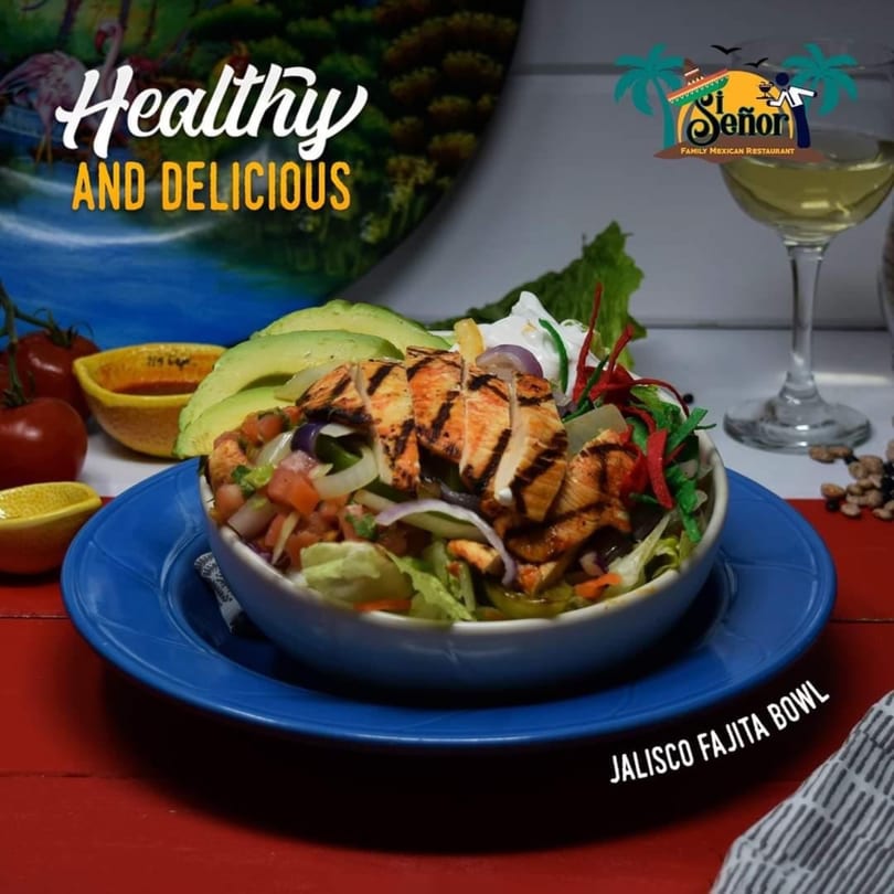 Jalisco Fajita Bowl with grilled chicken, avocado, and vegetables on a blue plate.