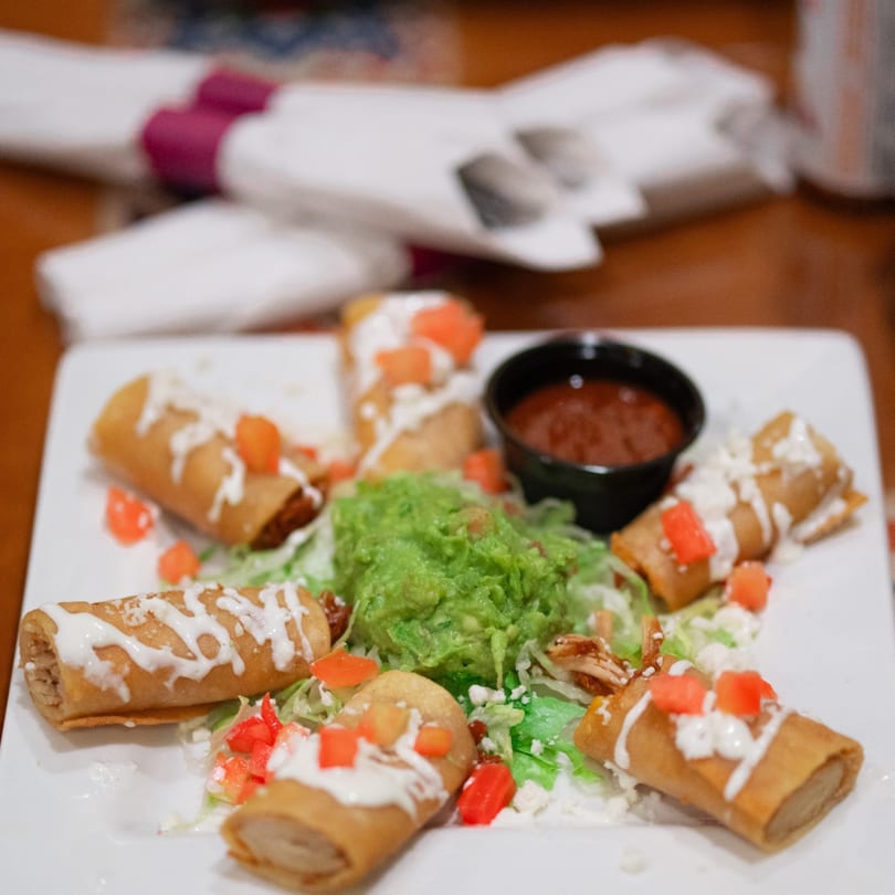 Crispy taquitos drizzled with crema, topped with diced tomatoes, served with guacamole and salsa.